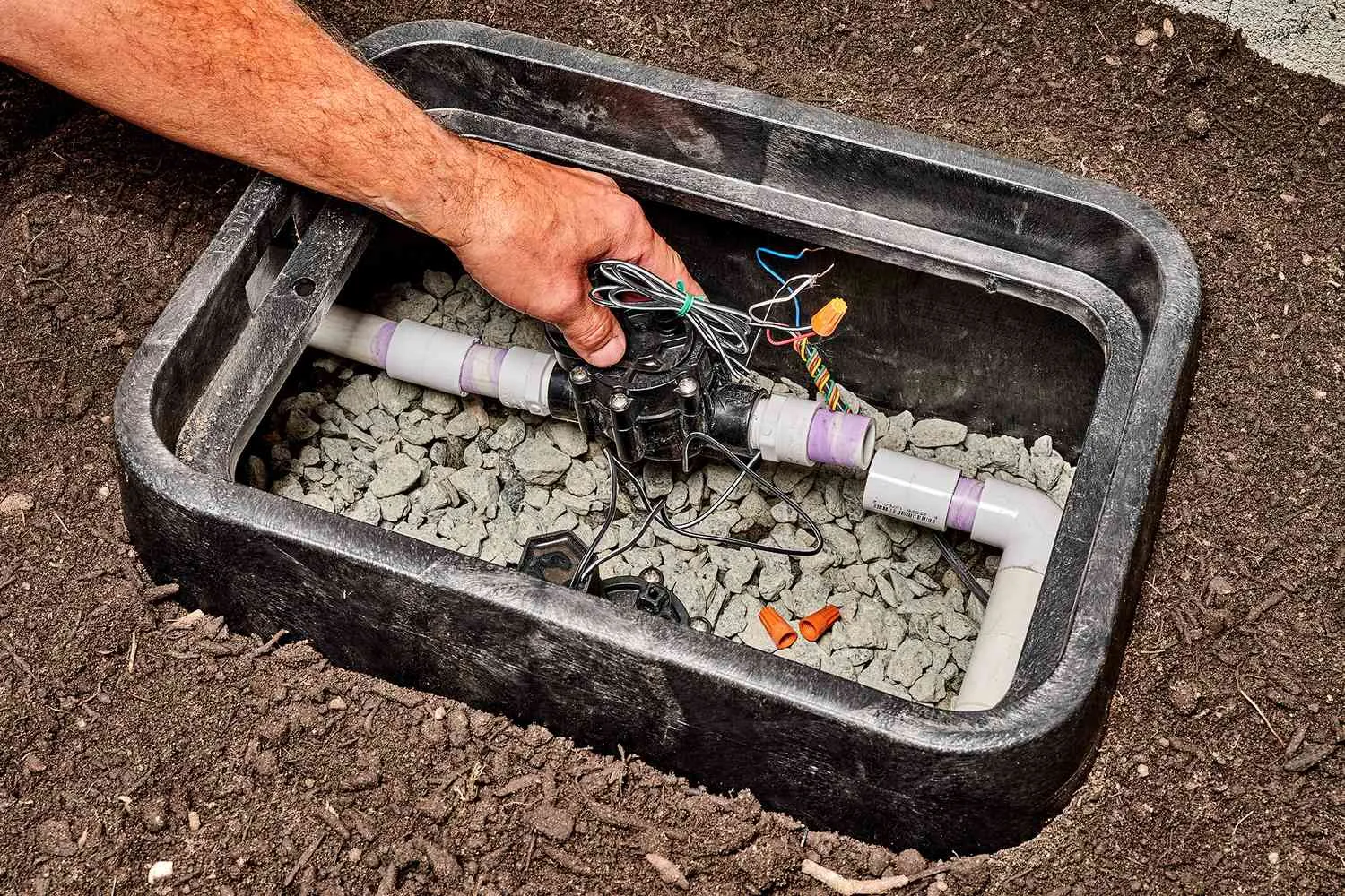 Technician repairing irrigation valve